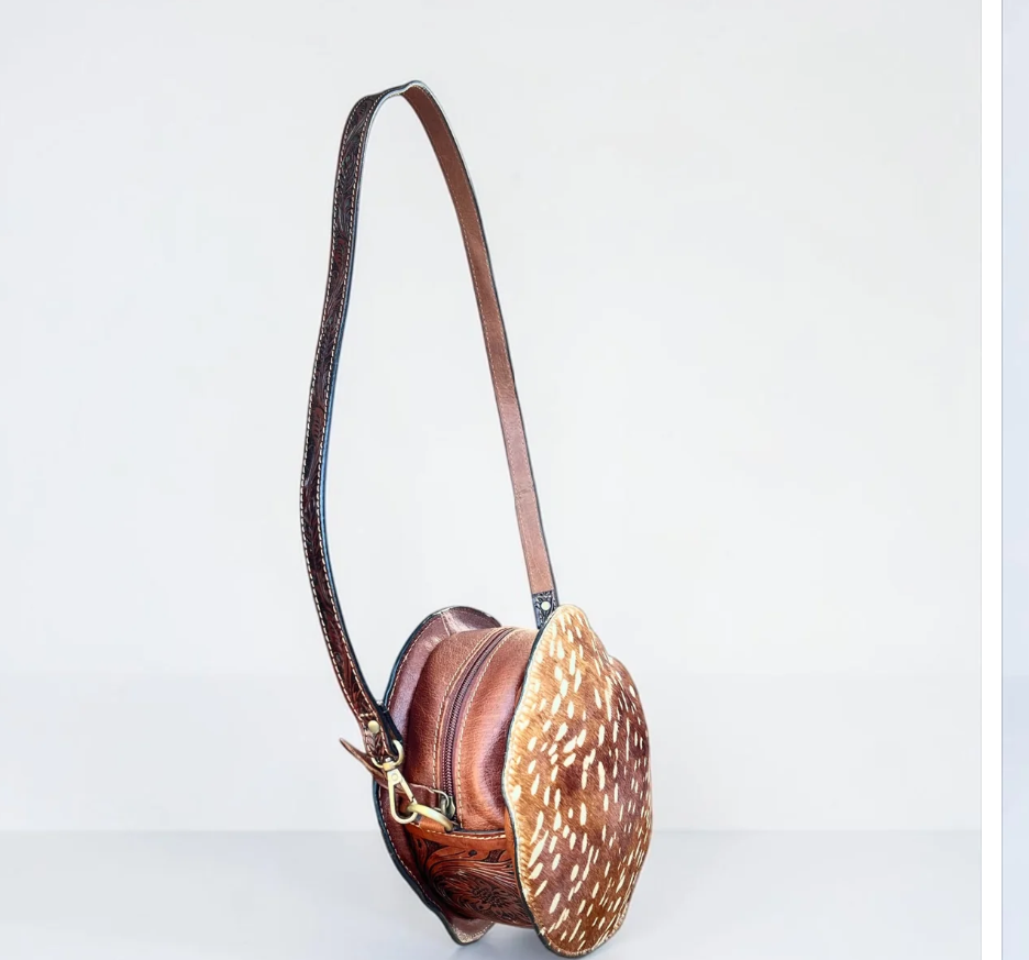 Tooled leather & cowhide canteen bag with brown tooled leather, tan spotted hide, and a long shoulder strap