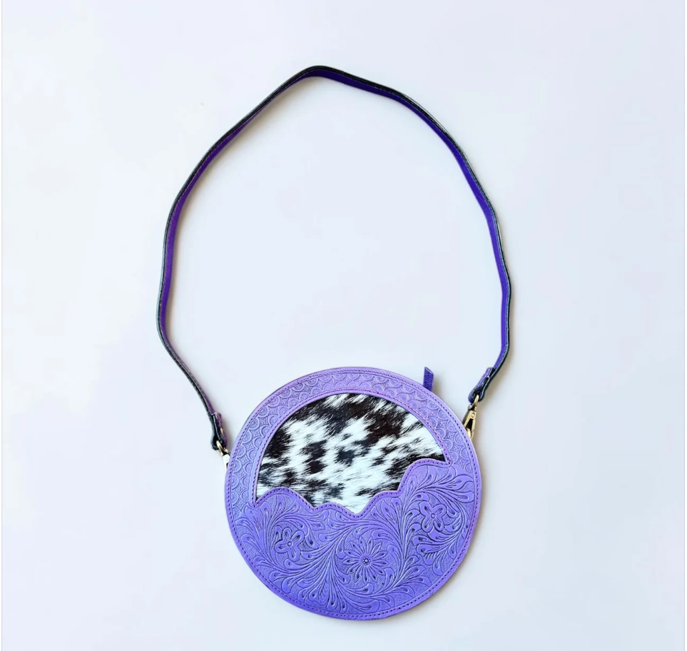Tooled leather & cowhide canteen bag in purple leather with engraved floral tooling, black-and-white cowhide and a shoulder strap