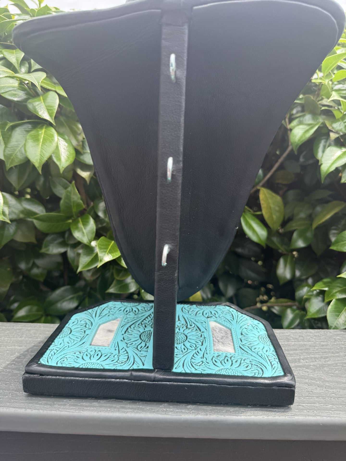 Medium Turquoise tooled Leather Necklace Display with black and white cowhide background